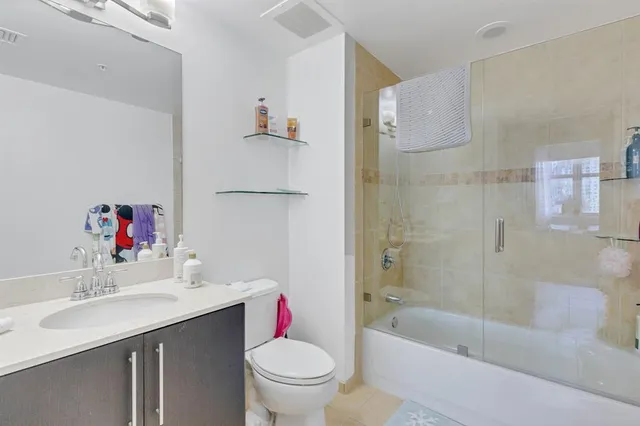 a view of a dining room with furniture and a chandelier