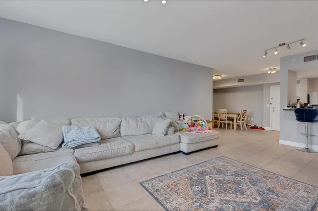a living room with furniture and white walls