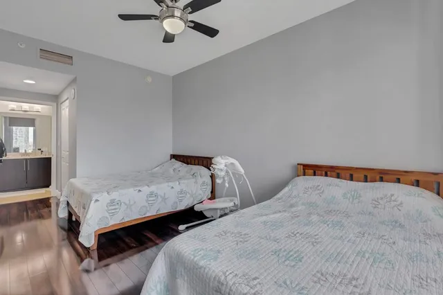 a bedroom with two beds and white walls