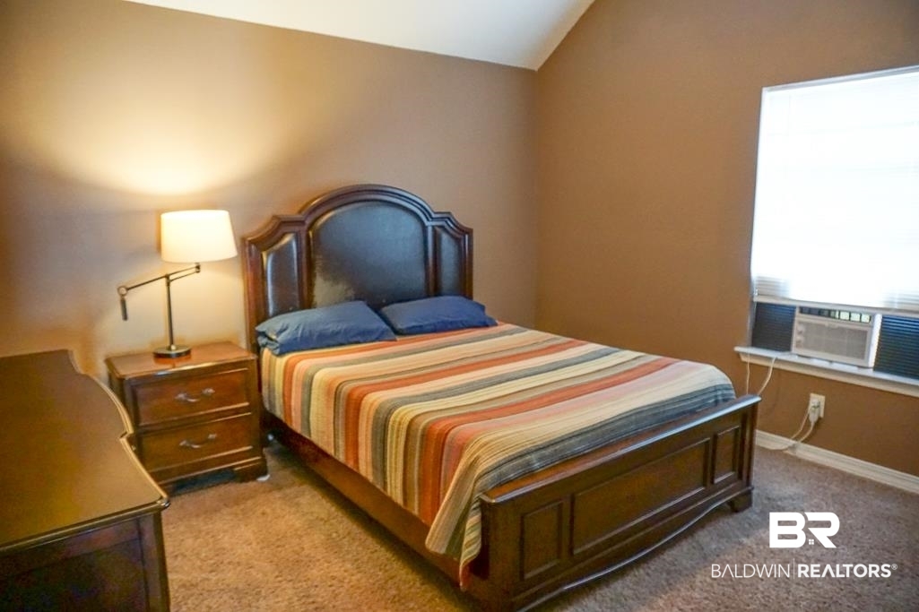 254 Thrift Street Mobile, AL 36609 - Photo 11 of 16 Carpeted bedroom featuring lofted ceiling and baseboards