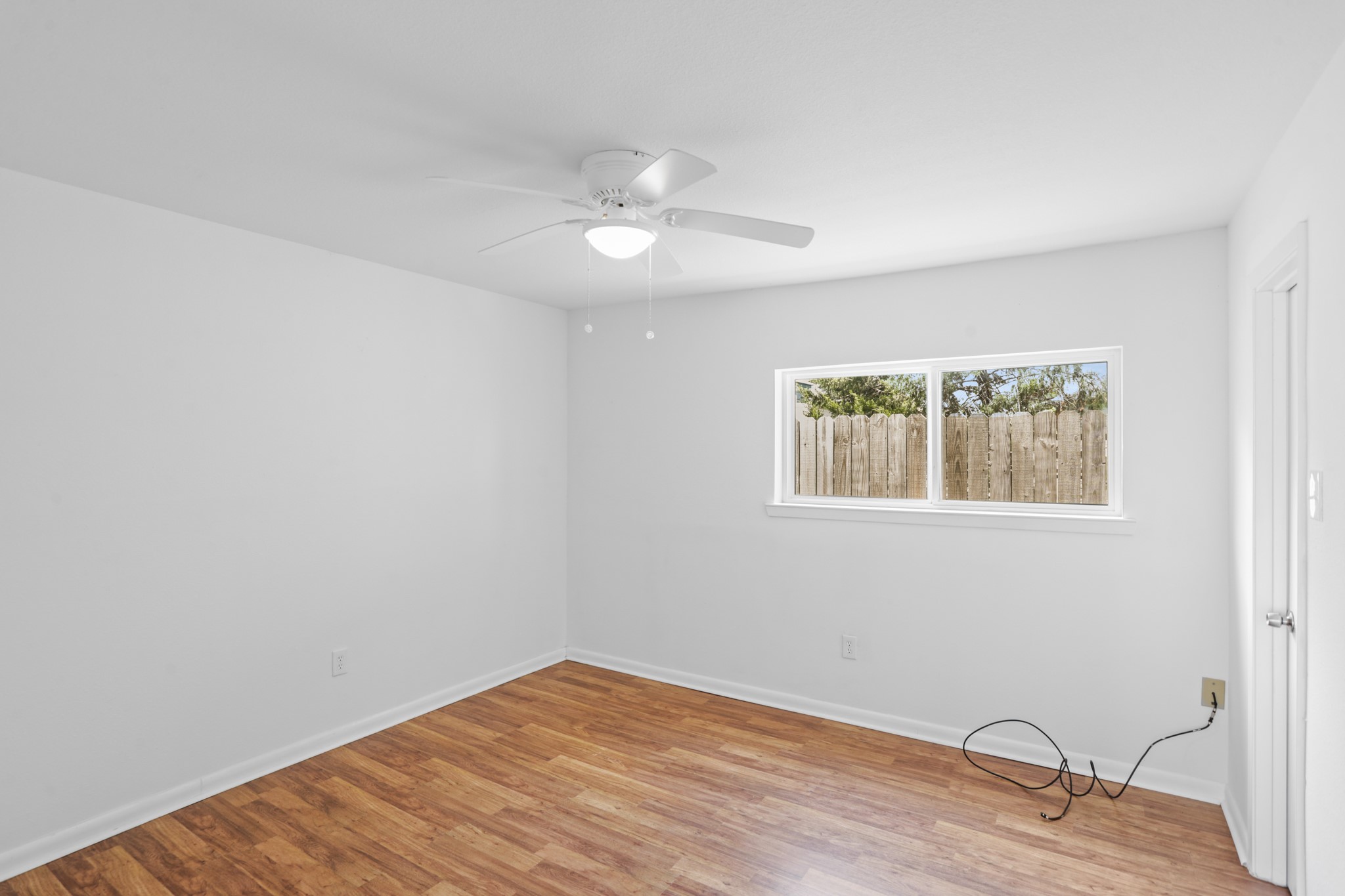 1408 Hughes Street, Unit 4 Houston, TX 77023 - Photo 21 of 27 The bedroom has updated windows, ceiling fan and laminate flooring.