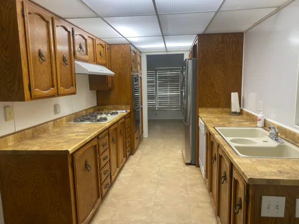 a kitchen that has a sink and a stove