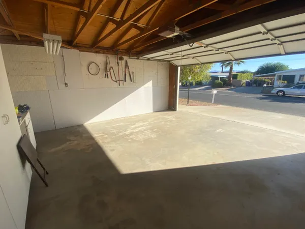 a view of a house with a backyard and a tree