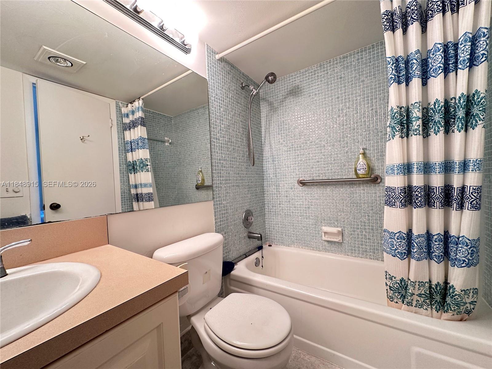 569 Fanshaw North, Unit 569 Boca Raton, FL 33434 - Photo 21 of 24 a bathroom with a sink a toilet and shower