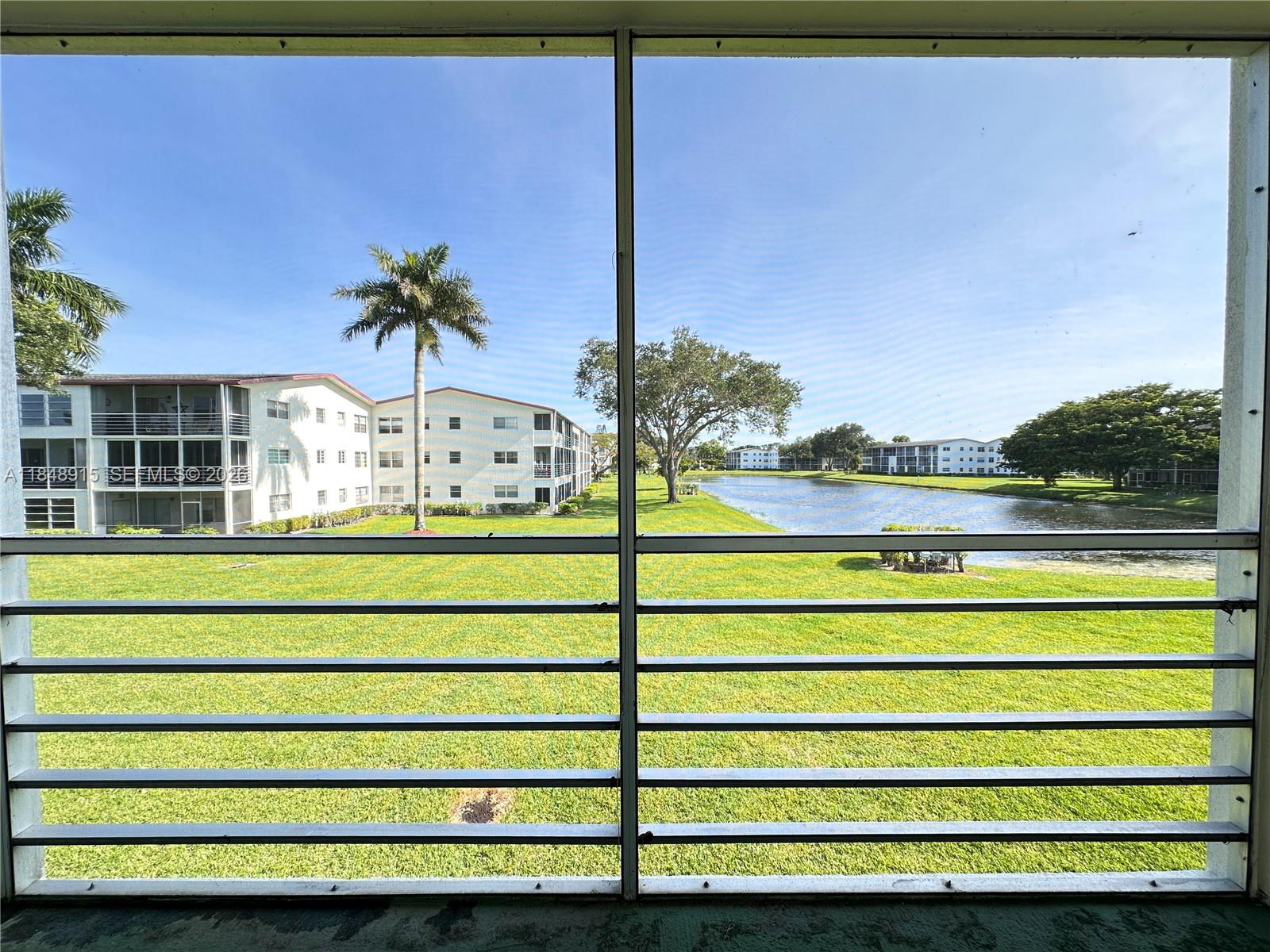 569 Fanshaw North, Unit 569 Boca Raton, FL 33434 - Photo 4 of 24 a view of a bench in front of building