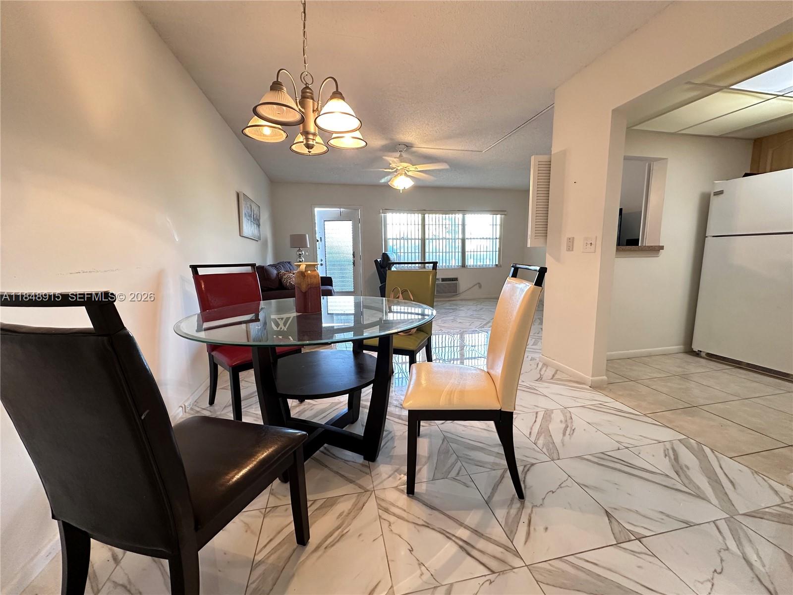 569 Fanshaw North, Unit 569 Boca Raton, FL 33434 - Photo 10 of 24 a dining room with furniture and window