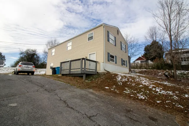a view of a car park in front of house