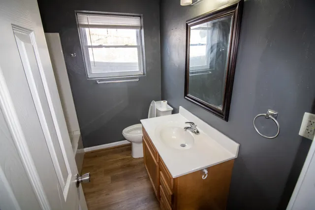 a bathroom with a sink a toilet and mirror