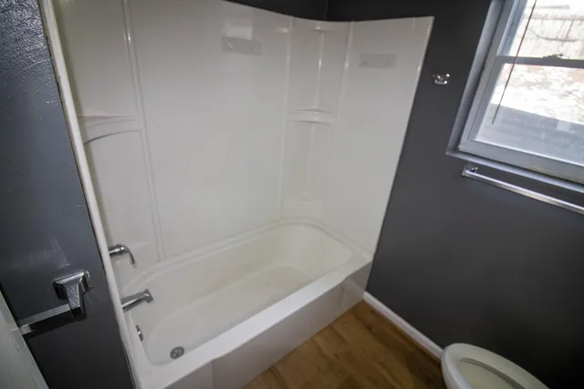 a bathroom with a bathtub and toilet