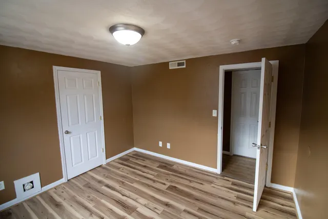 a view of a livingroom with wooden floor and closet