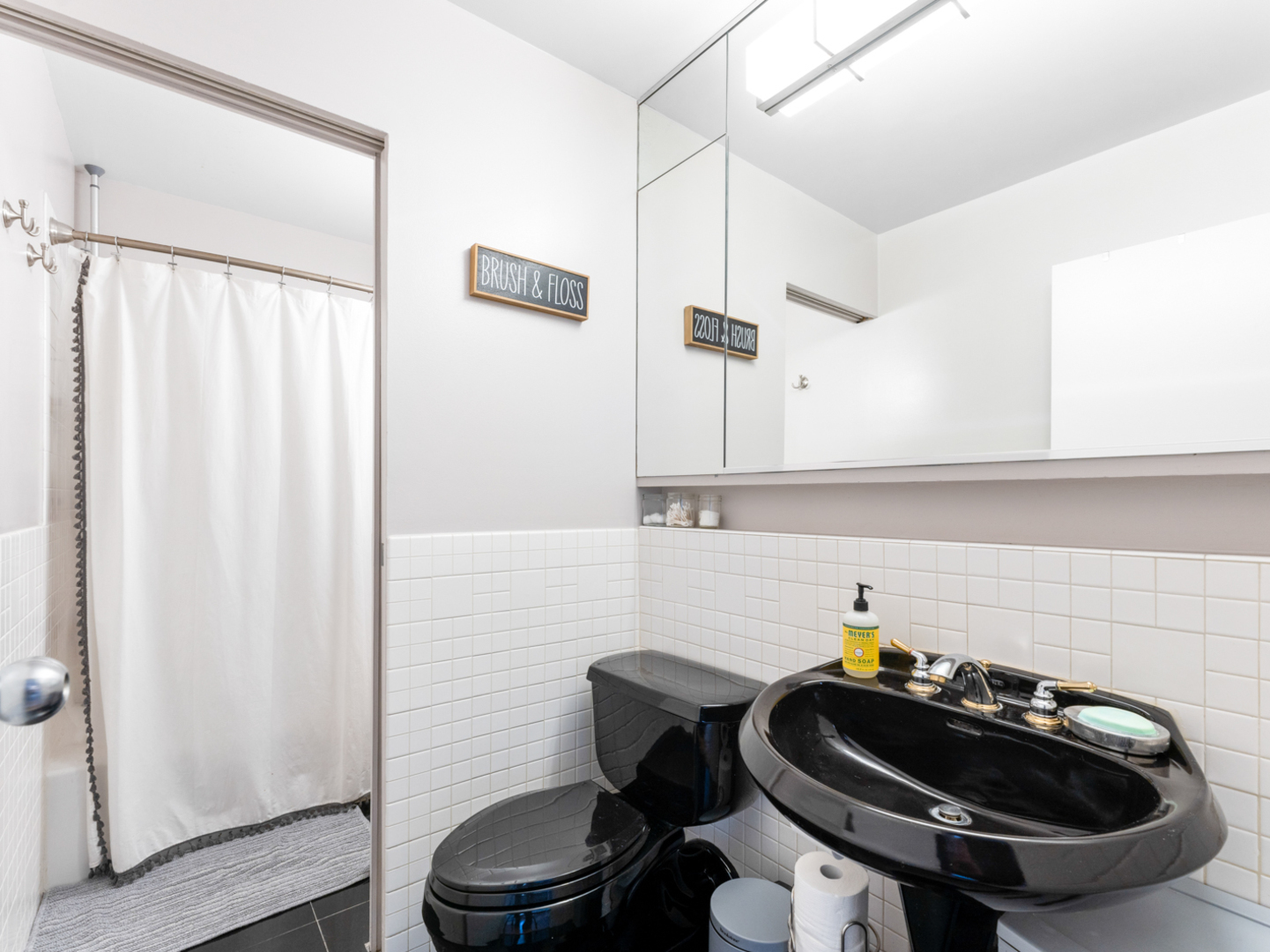 40 East 9th Street, Unit 1502 Chicago, IL 60605 - Photo 17 of 36 a bathroom with a sink a toilet and shower curtain