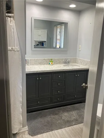 a bathroom with a sink vanity and mirror