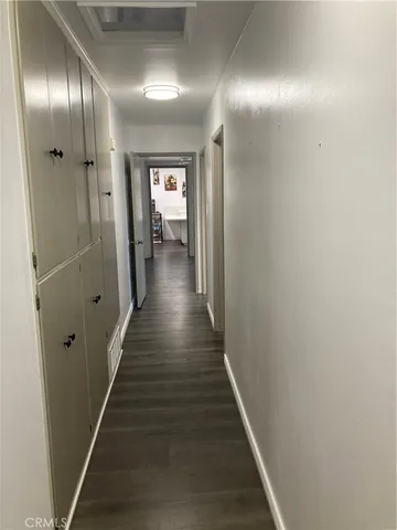 a view of a hallway with wooden floor