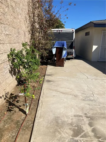 a bedroom with a bed and a potted plant