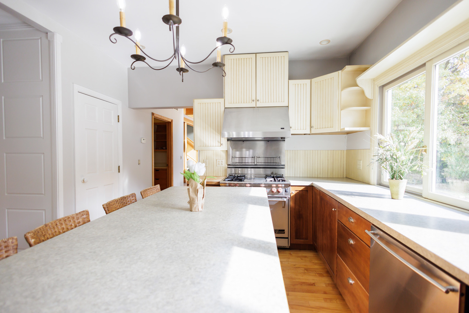 5034 East Boy Scout Road St. Anne, IL 60964 - Photo 13 of 50 a kitchen with stainless steel appliances granite countertop a sink a stove a refrigerator a microwave oven with cabinets and wooden floor