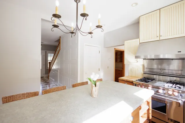 a kitchen with stainless steel appliances granite countertop a sink a stove and a refrigerator