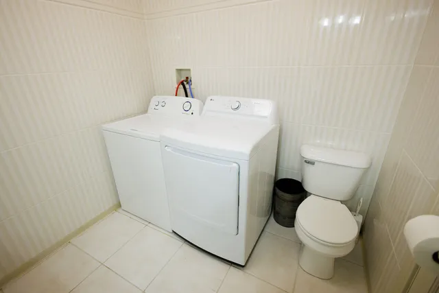 a white toilet sitting next to a white sink