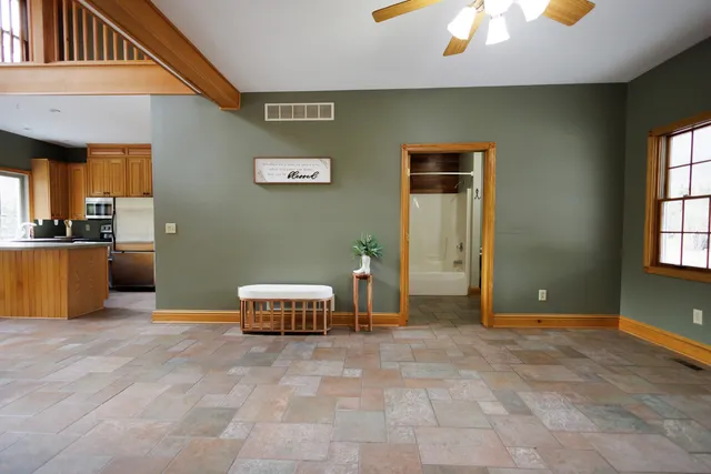 a view of a livingroom with furniture and staircase
