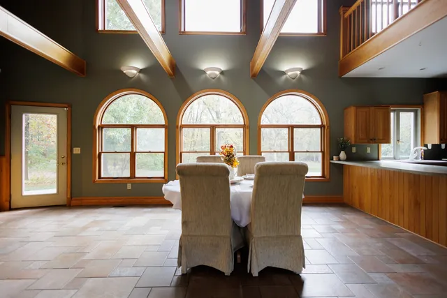 a spacious bedroom with a bed and large windows