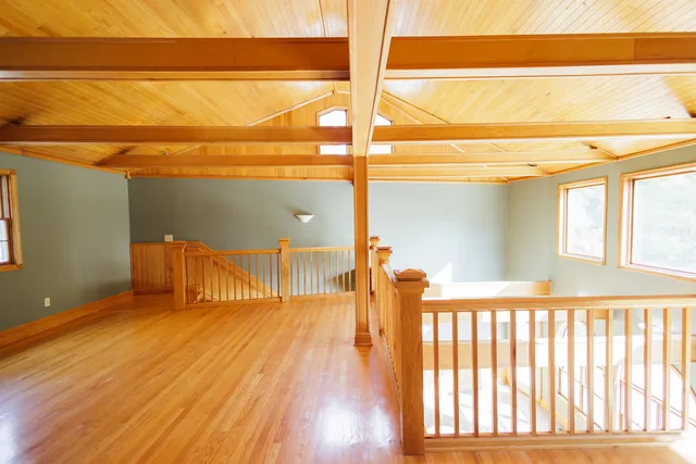 a view of a room with wooden floor and door