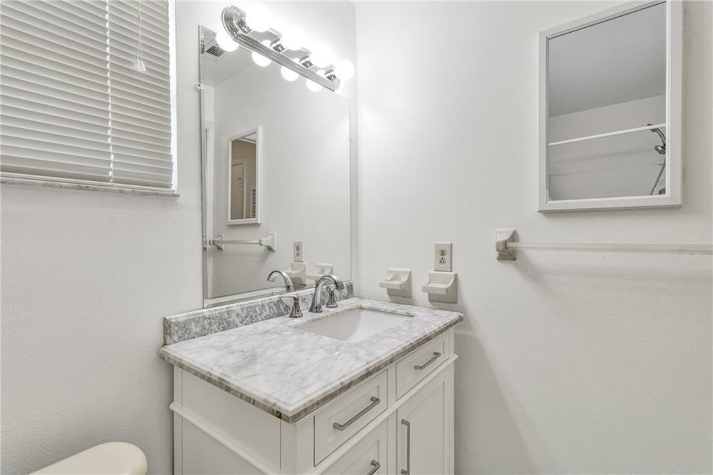 8520 Highway 1, Unit 11 Sebastian, FL 32976 - Photo 16 of 21 a bathroom with a granite countertop sink and a mirror