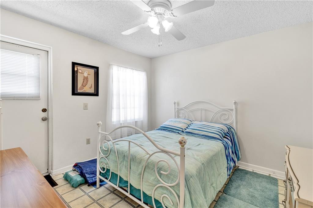 8520 Highway 1, Unit 11 Sebastian, FL 32976 - Photo 18 of 21 a bedroom with a bed and a chandelier