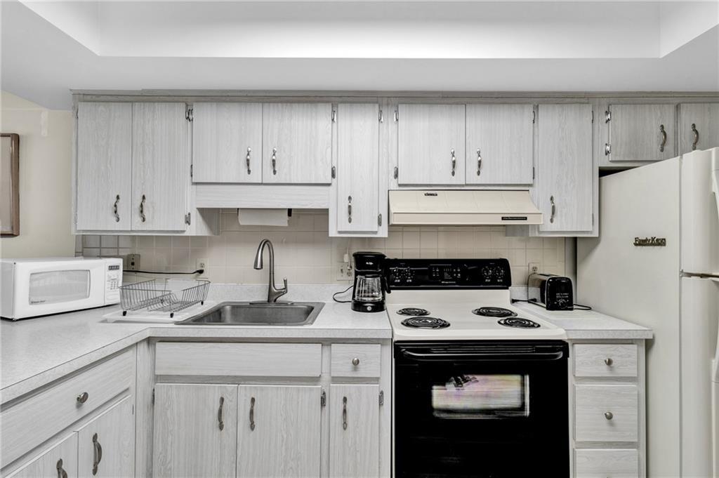 8520 Highway 1, Unit 11 Sebastian, FL 32976 - Photo 7 of 21 a kitchen with stainless steel appliances granite countertop a refrigerator sink and cabinets