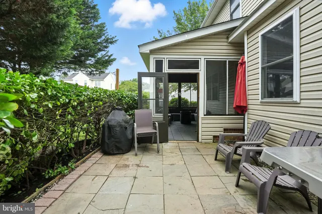 a view of a patio with table and chairs and potted plants