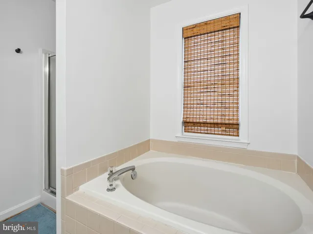 a white bath tub sitting next to a window