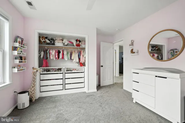 a view of living room with cabinets and wooden floor