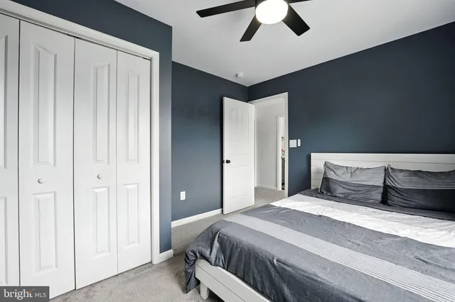 a bedroom with a large bed and a chandelier