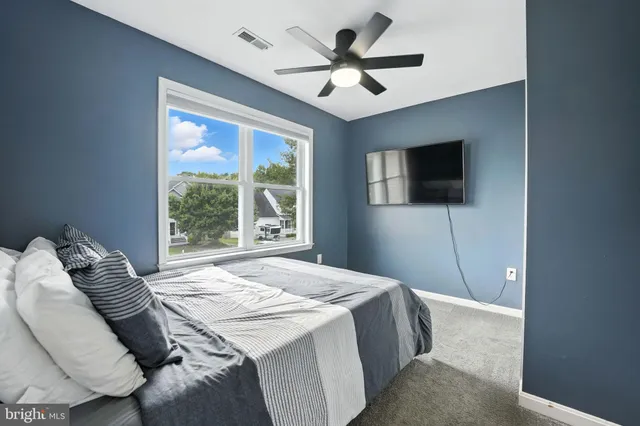 a bedroom with a large bed and a flat screen tv