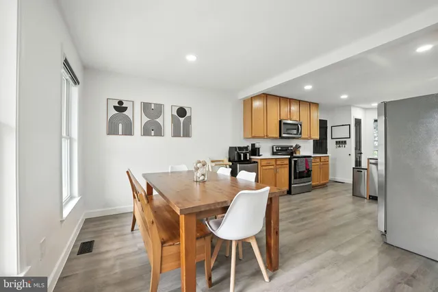 a view of a dining room with furniture and a kitchen