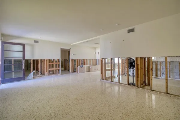 a view of a hall with wooden floor