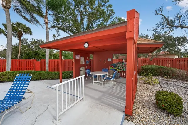 a view of a patio with a table chairs and a backyard