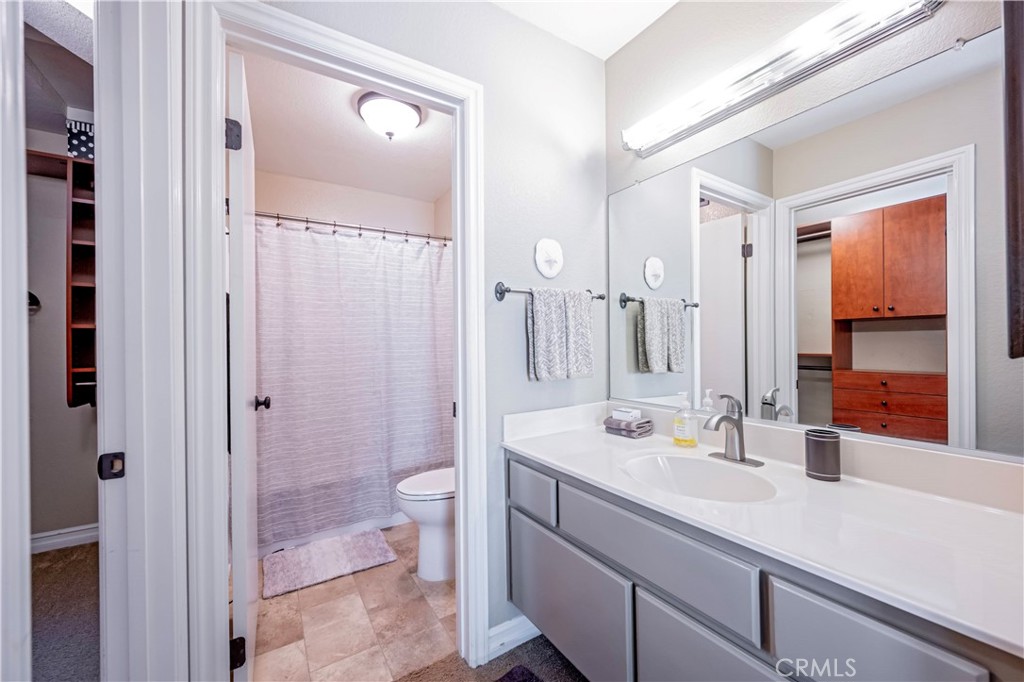 10 Corniche Drive, Unit E Dana Point, CA 92629 - Photo 14 of 25 a bathroom with a sink a toilet a shower and a mirror