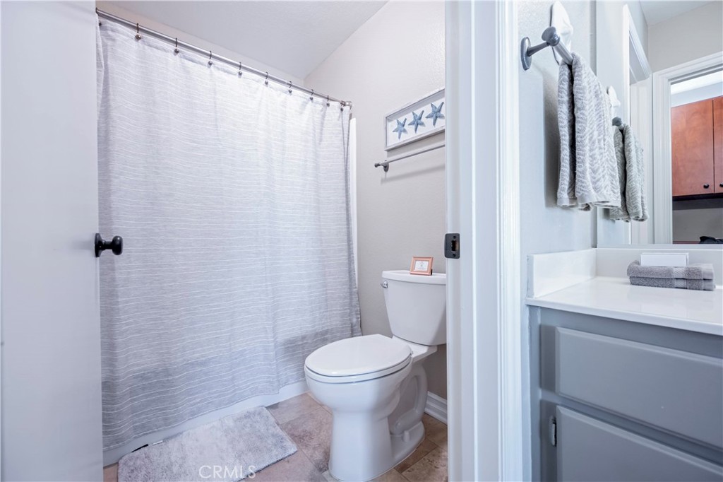 10 Corniche Drive, Unit E Dana Point, CA 92629 - Photo 15 of 25 a bathroom with a granite countertop sink toilet and shower
