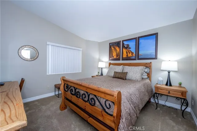 a bedroom with a bed and a night stand