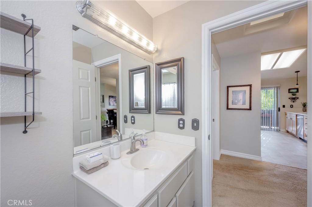 10 Corniche Drive, Unit E Dana Point, CA 92629 - Photo 20 of 25 a bathroom with a sink and a mirror