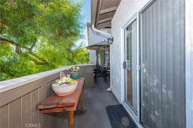 a view of a balcony with chairs and a yard