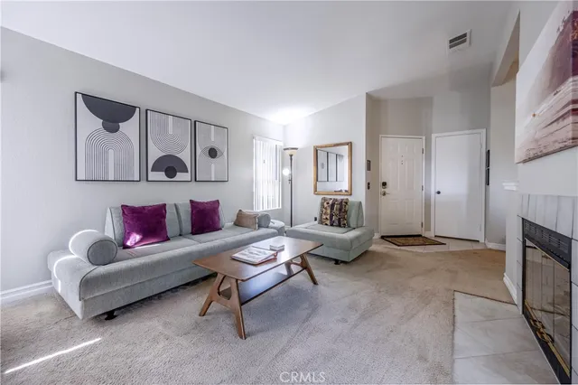 a living room with furniture and a fireplace