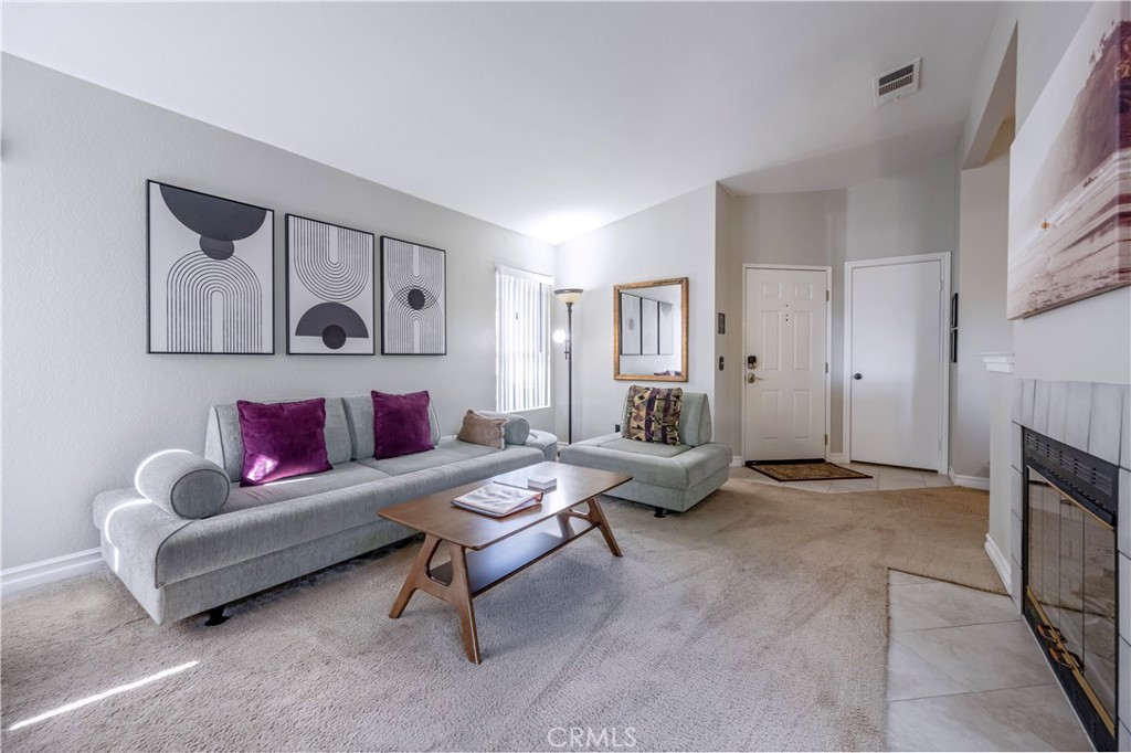 10 Corniche Drive, Unit E Dana Point, CA 92629 - Photo 3 of 25 a living room with furniture and a fireplace