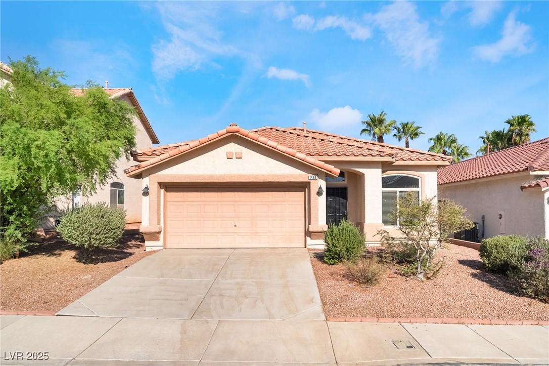 1498 Rancho Navarro Street Henderson, NV 89012 - Photo 3 of 35 Mediterranean / spanish home featuring stucco siding, an attached garage, driveway, and a tiled roof