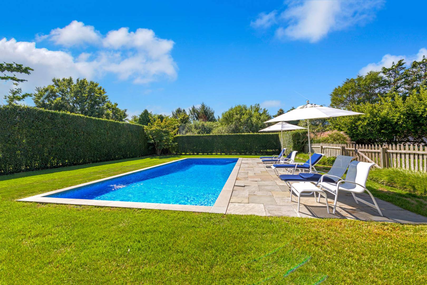 760 North Sea Mecox Road Southampton, NY 11968 - Photo 23 of 24 a view of a swimming pool with lounge chairs in patio