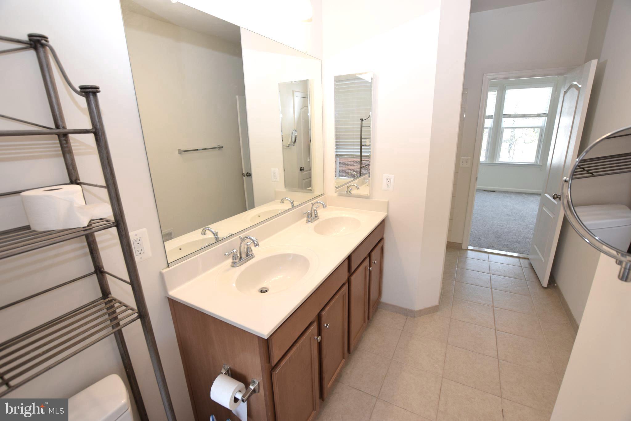 8922 Center Street Manassas, VA 20110 - Photo 16 of 24 a bathroom with a sink a toilet and a mirror