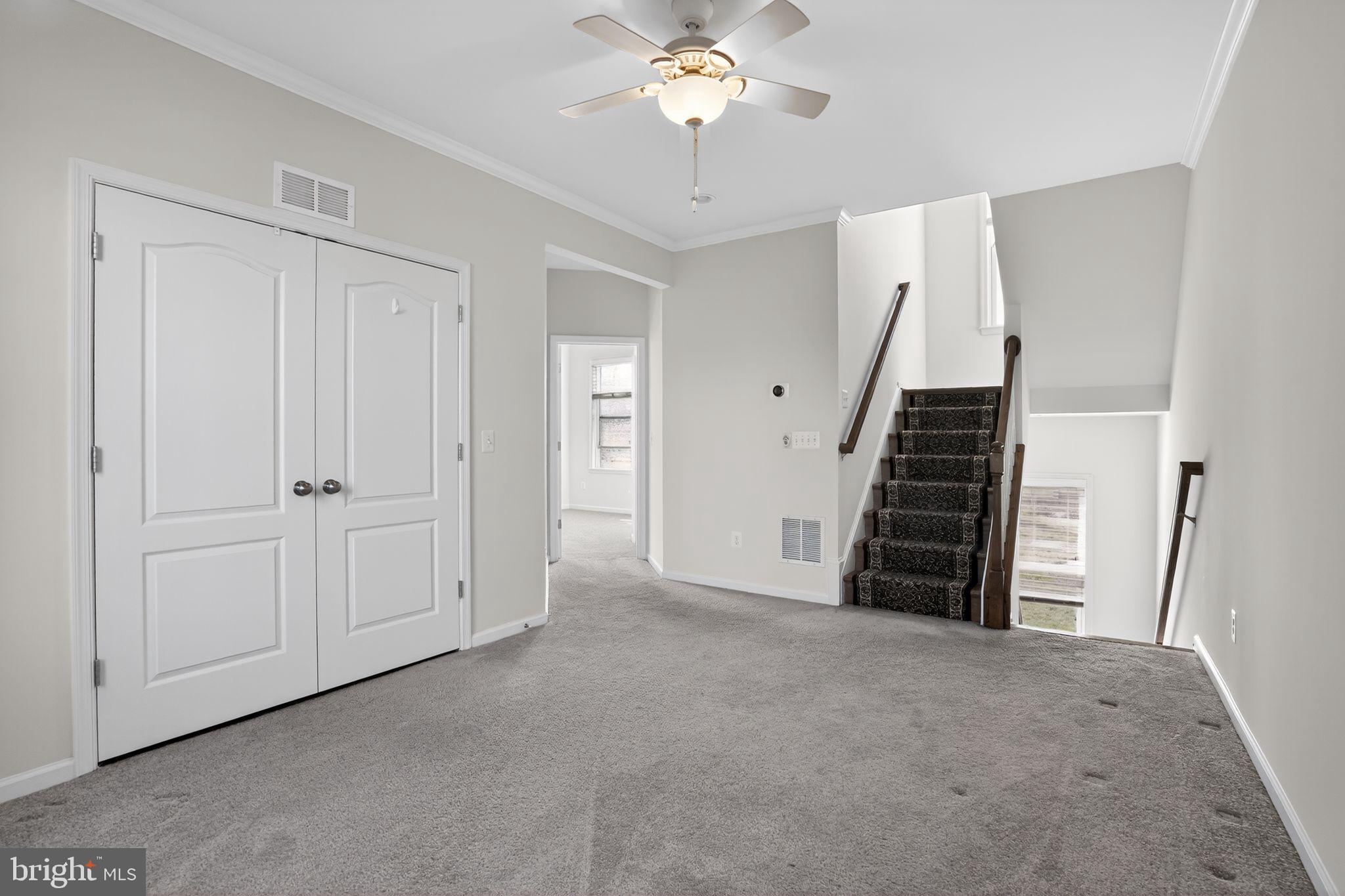 8922 Center Street Manassas, VA 20110 - Photo 19 of 24 a view of an empty room with a ceiling fan