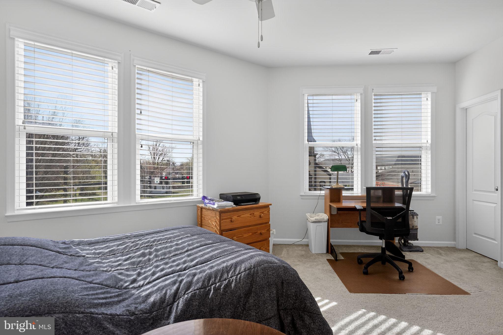 8922 Center Street Manassas, VA 20110 - Photo 20 of 24 a bedroom with a bed a table and a window