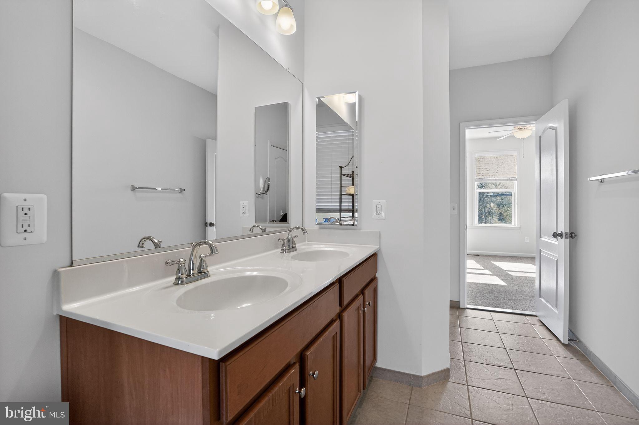 8922 Center Street Manassas, VA 20110 - Photo 21 of 24 a bathroom with a sink a toilet and a mirror