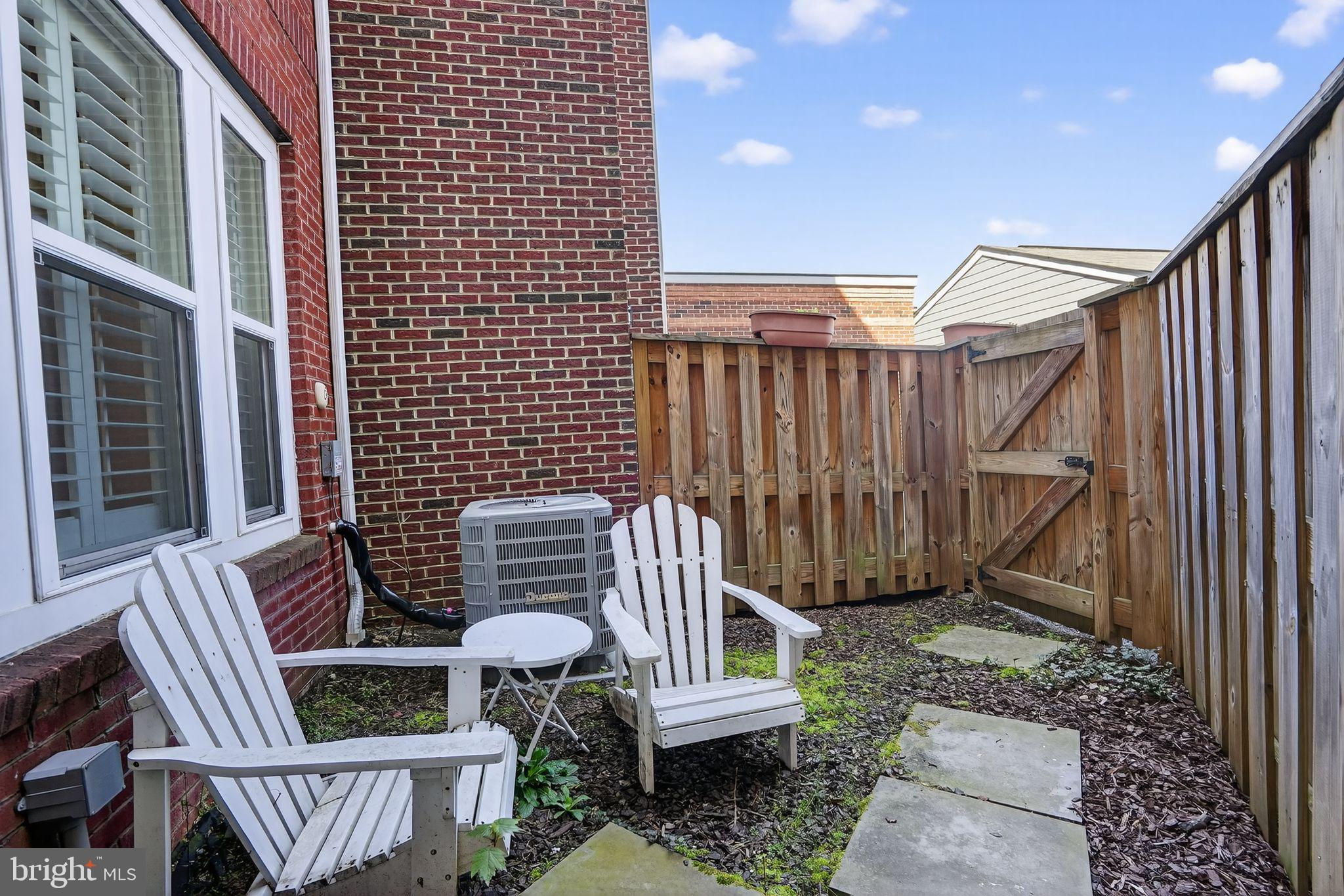8922 Center Street Manassas, VA 20110 - Photo 22 of 24 a view of wooden door with chair and wooden fence