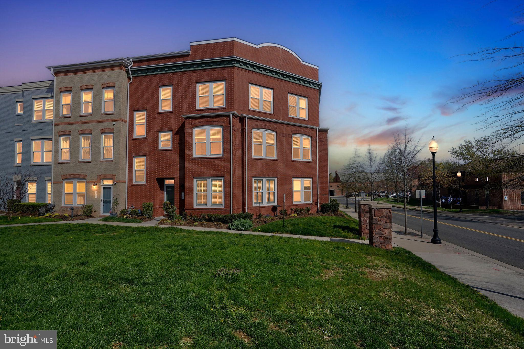 8922 Center Street Manassas, VA 20110 - Photo 3 of 24 a large brick building with a yard in front of it